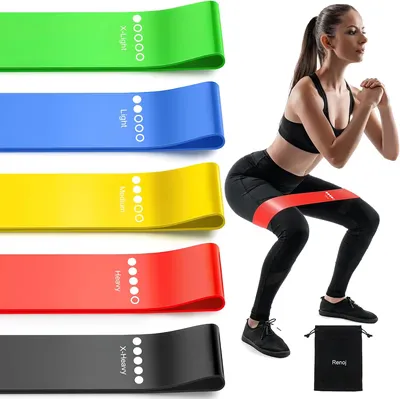 Set of five resistance loop bands beside a woman performing squats